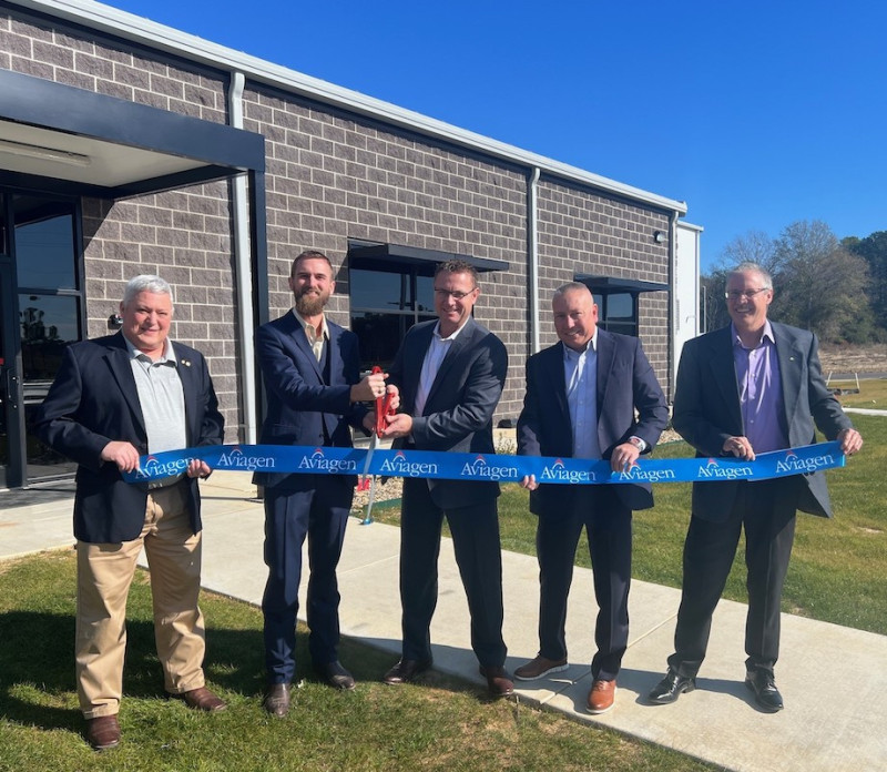Five participants cutting the ribbon at the hatchery